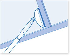 Paint or stain between deck and fence boards with extension pole
